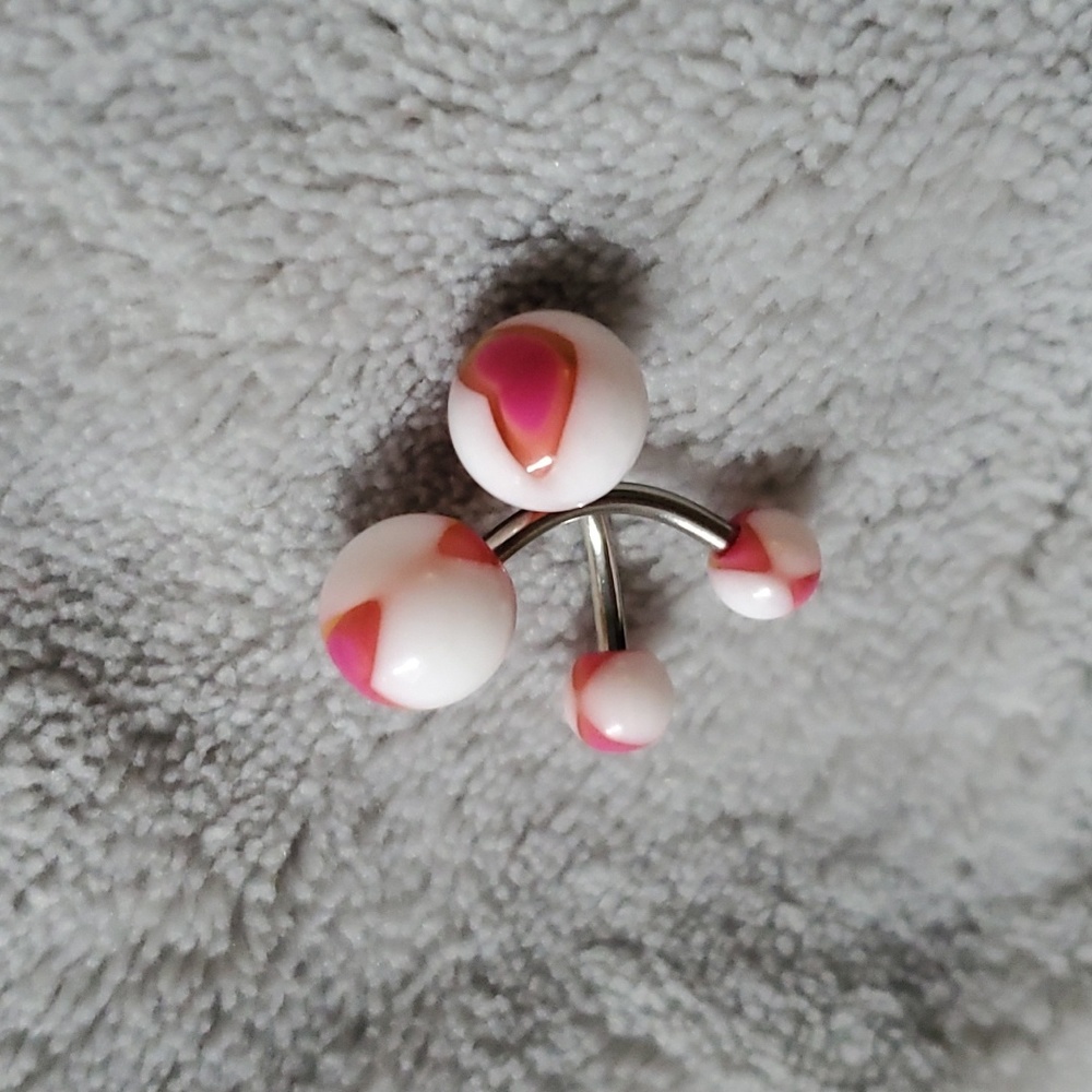 Two plastic and surgical steel navel belly rings.